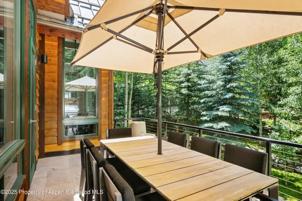 a view of a balcony with a table and chairs