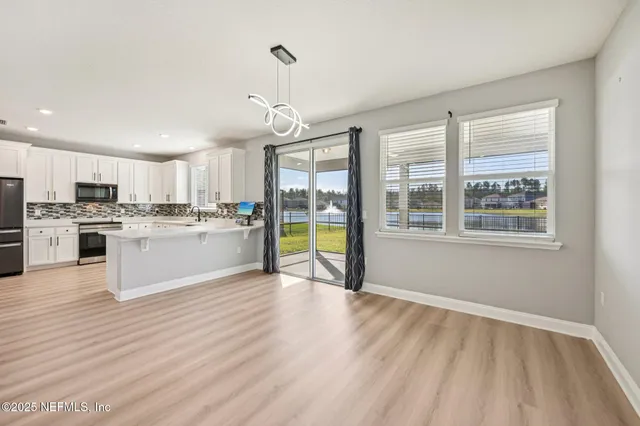 an empty room with a ceiling fan and a window