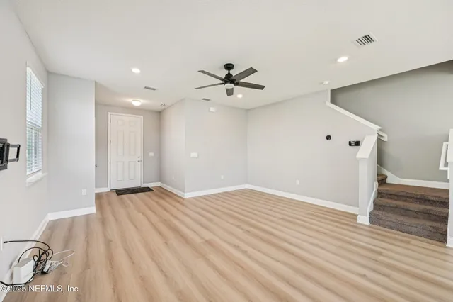 a spacious bathroom with a shower sink and mirror
