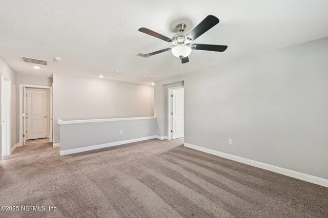 a house view with swimming pool and trees in the background