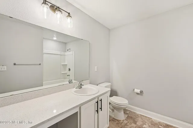 a view of a swimming pool with a lawn chairs under an umbrella