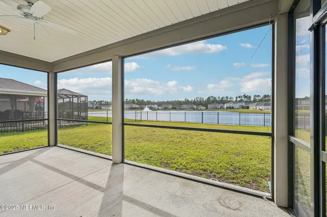 a living room with furniture a flat screen tv and a window