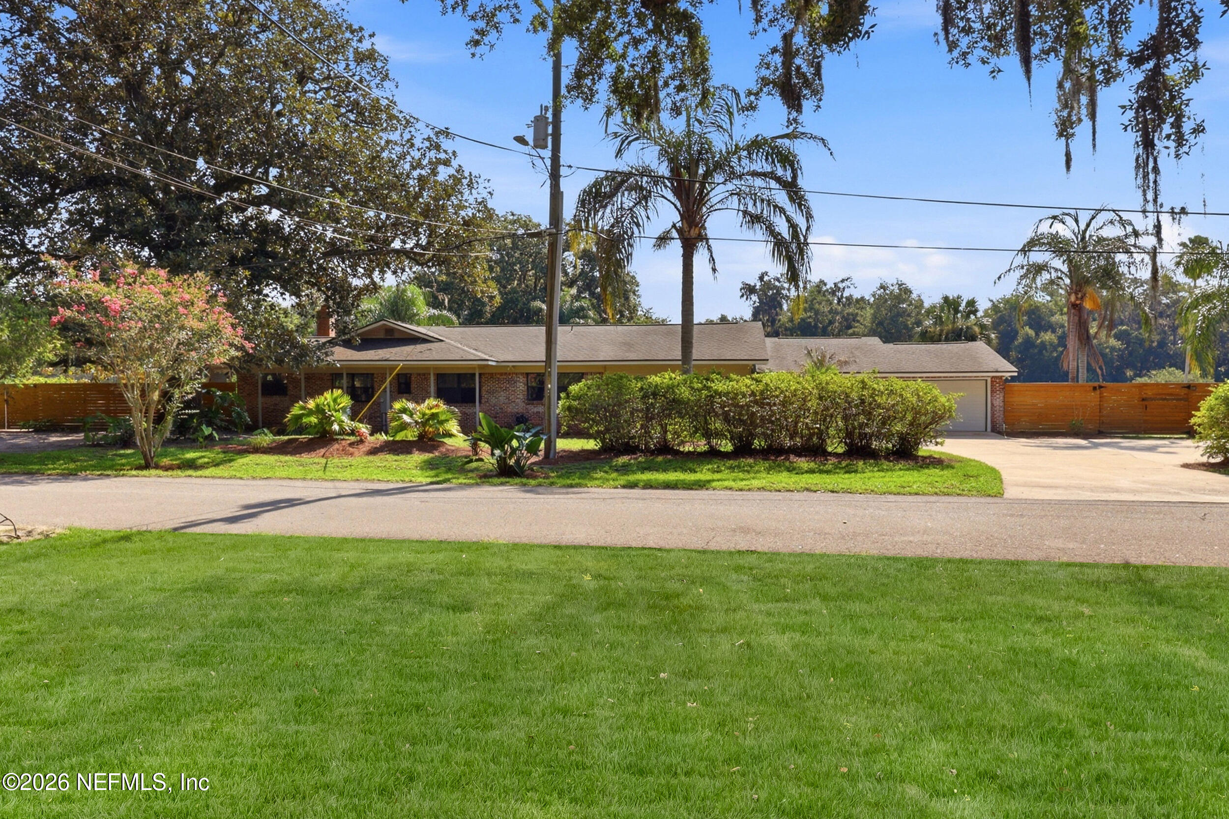11627 Mandarin Terrace Road Jacksonville, FL 32223 - Photo 4 of 79 a front view of a house with garden and trees