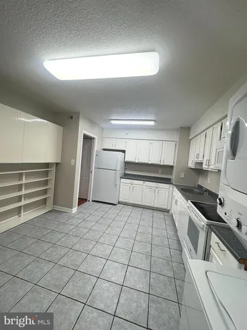 a kitchen with granite countertop a sink and cabinets