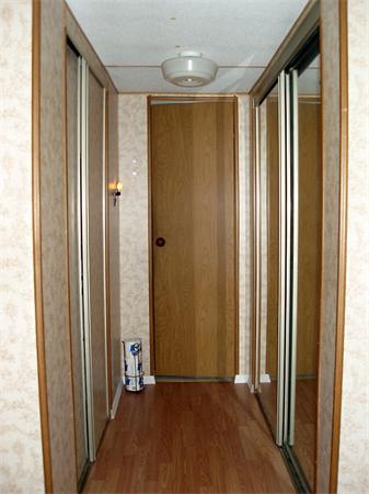 L-99-239 Ayer Road Littleton, MA 01460 - Photo 5 of 10 a view of a hallway with wooden floor and a bathroom