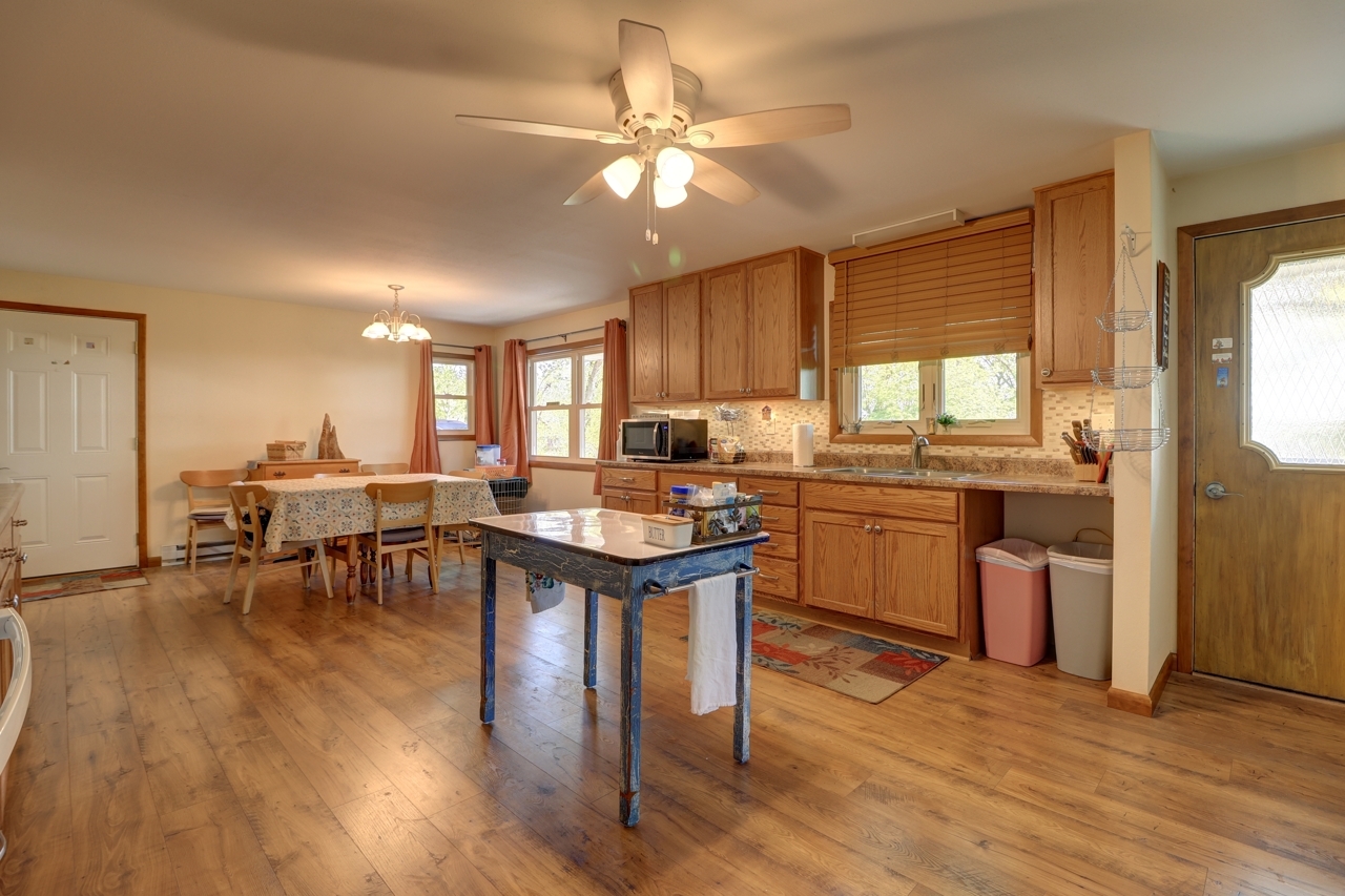 14755 Fenton Road Morrison, IL 61270 - Photo 5 of 34 a kitchen with a sink cabinets and wooden floor