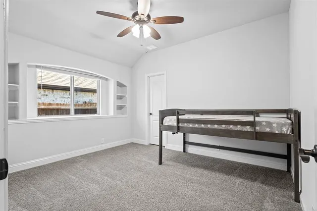 a view of room with window and ceiling fan