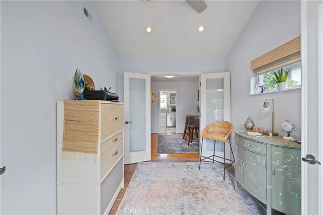 a living room with furniture and a dresser