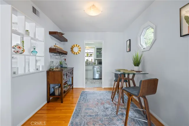 a view of a dining room with furniture and a potted plant