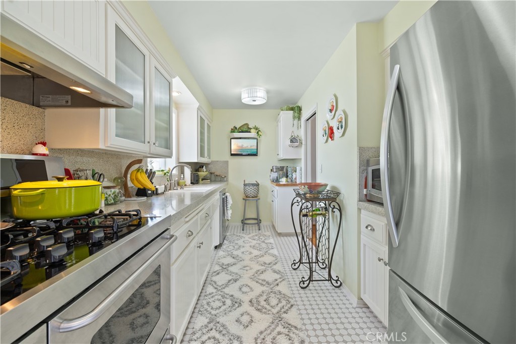 208 West Avenida De Los Lobos Marinos San Clemente, CA 92672 - Photo 16 of 33 a kitchen with stainless steel appliances granite countertop a refrigerator and a stove