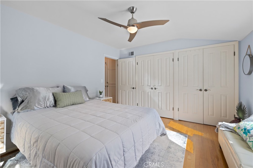 208 West Avenida De Los Lobos Marinos San Clemente, CA 92672 - Photo 21 of 33 a spacious bedroom with a bed and a chandelier