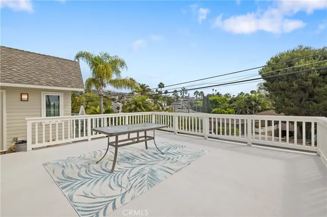 a view of a patio with couches table and chairs and potted plants