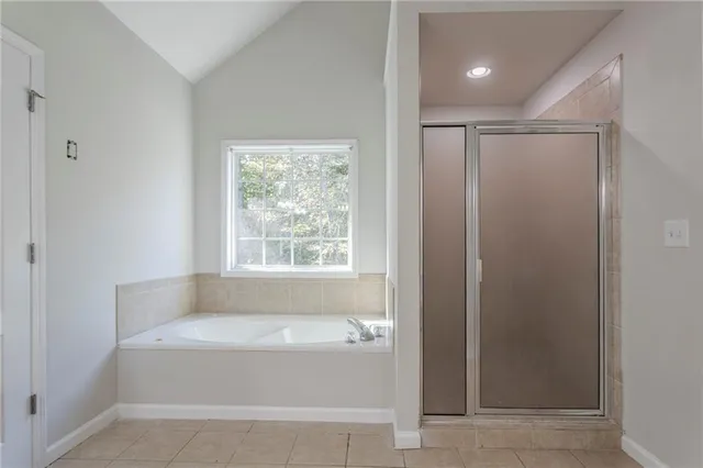 a bathroom with bathtub and window