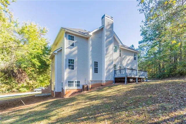 a view of a house with a yard and balcony