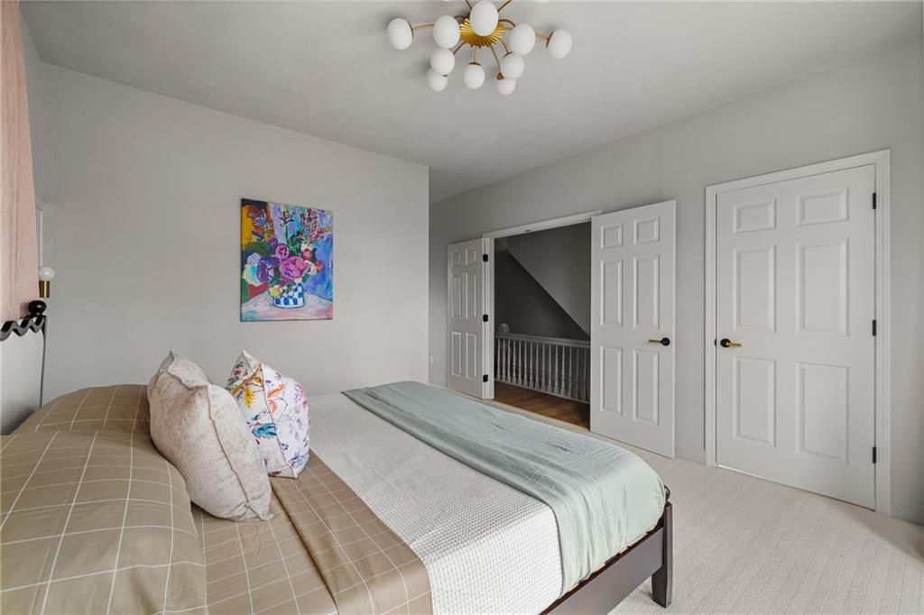 322 East Main Street Ligonier, PA 15658 - Photo 17 of 31 a bedroom with a bed and a chandelier