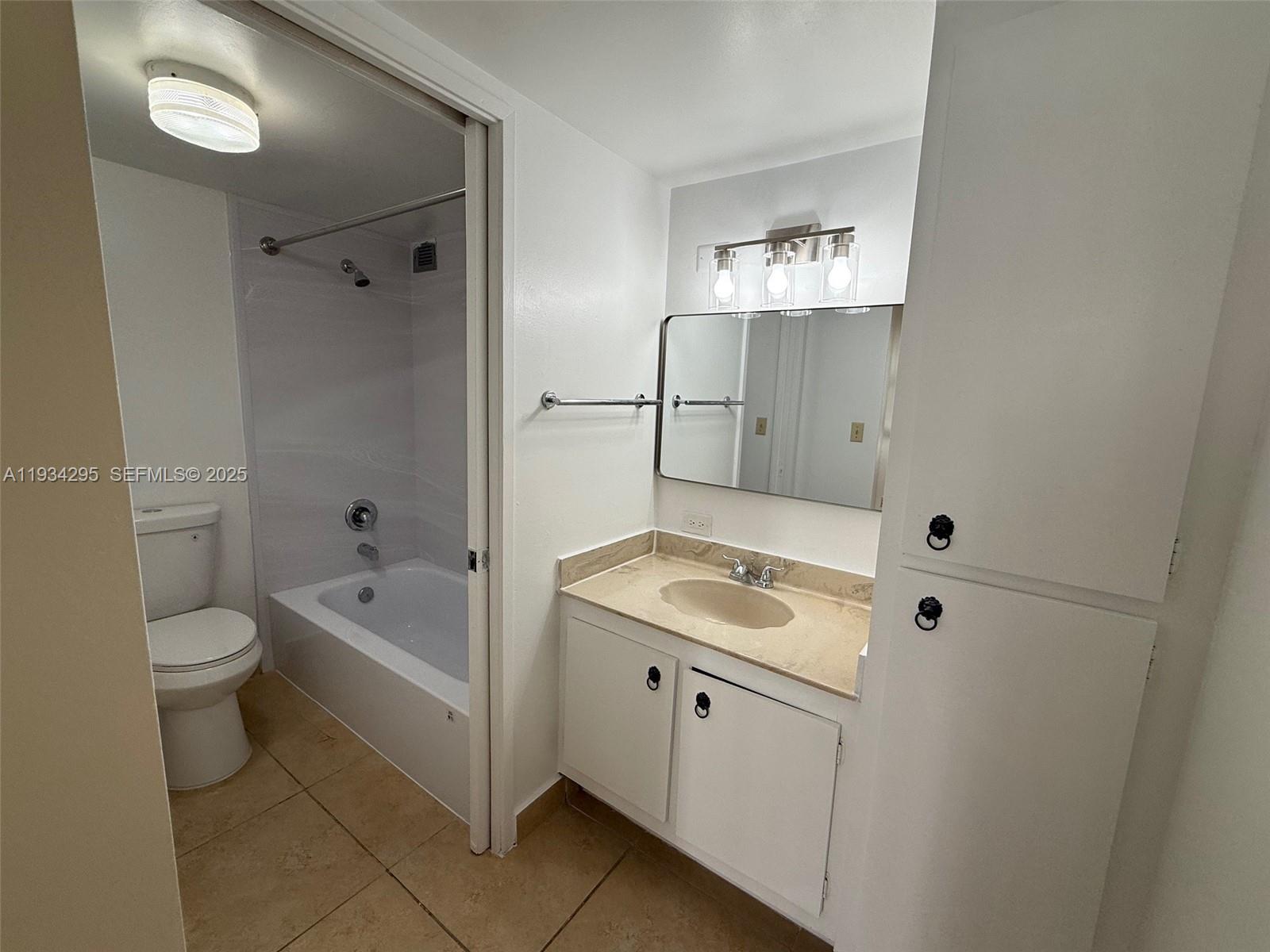 16919 North Bay Road, Unit 204 Sunny Isles Beach, FL 33160 - Photo 20 of 42 a bathroom with a toilet sink and mirror