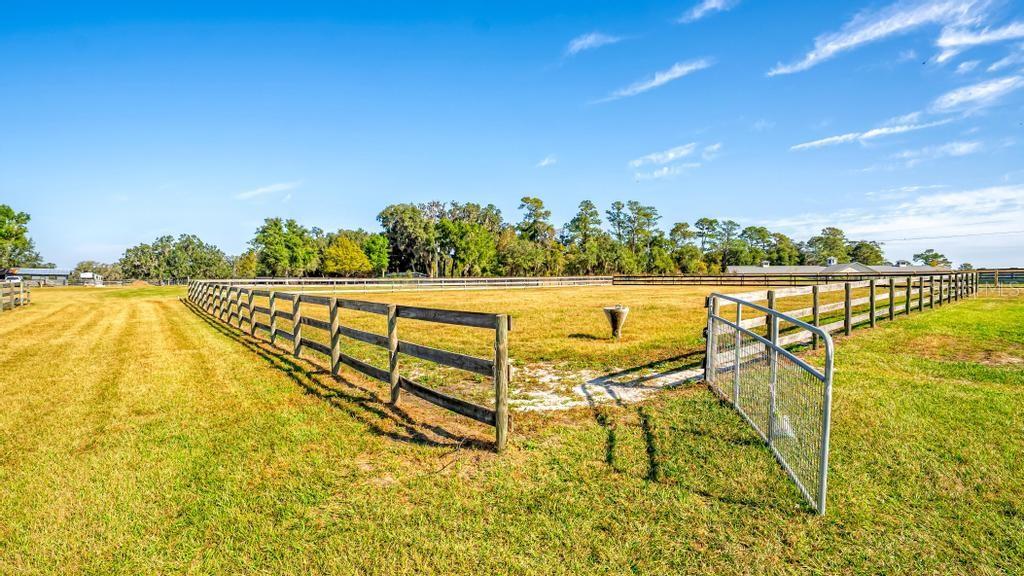 15305 Northwest 112th Place Road Morriston, FL 32668 - Photo 15 of 95 a view of an ocean with a table and chairs