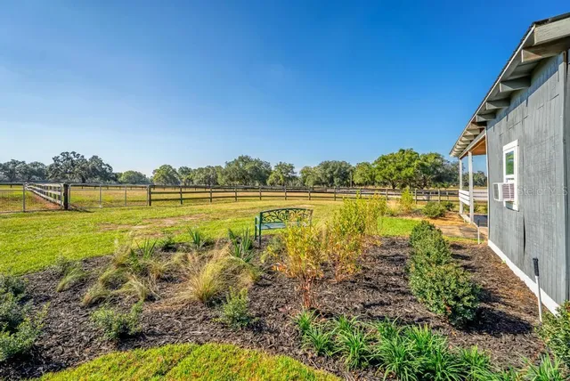 a dining room with wooden floor a chandelier a glass table and chairs