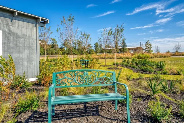a living room with furniture a flat screen tv and a window