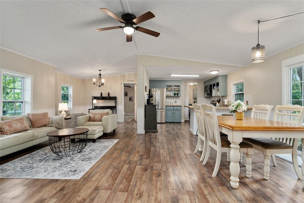 15305 Northwest 112th Place Road Morriston, FL 32668 - Photo 46 of 95 a living room with furniture kitchen view and a wooden floor