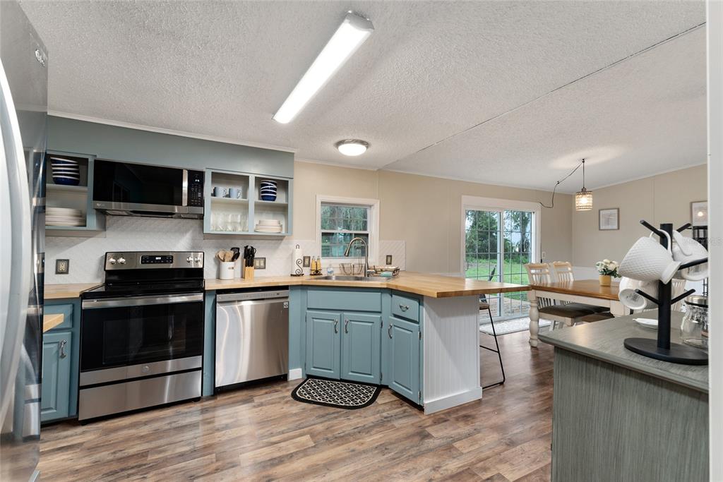15305 Northwest 112th Place Road Morriston, FL 32668 - Photo 52 of 95 a kitchen with lots of counter top space and appliances