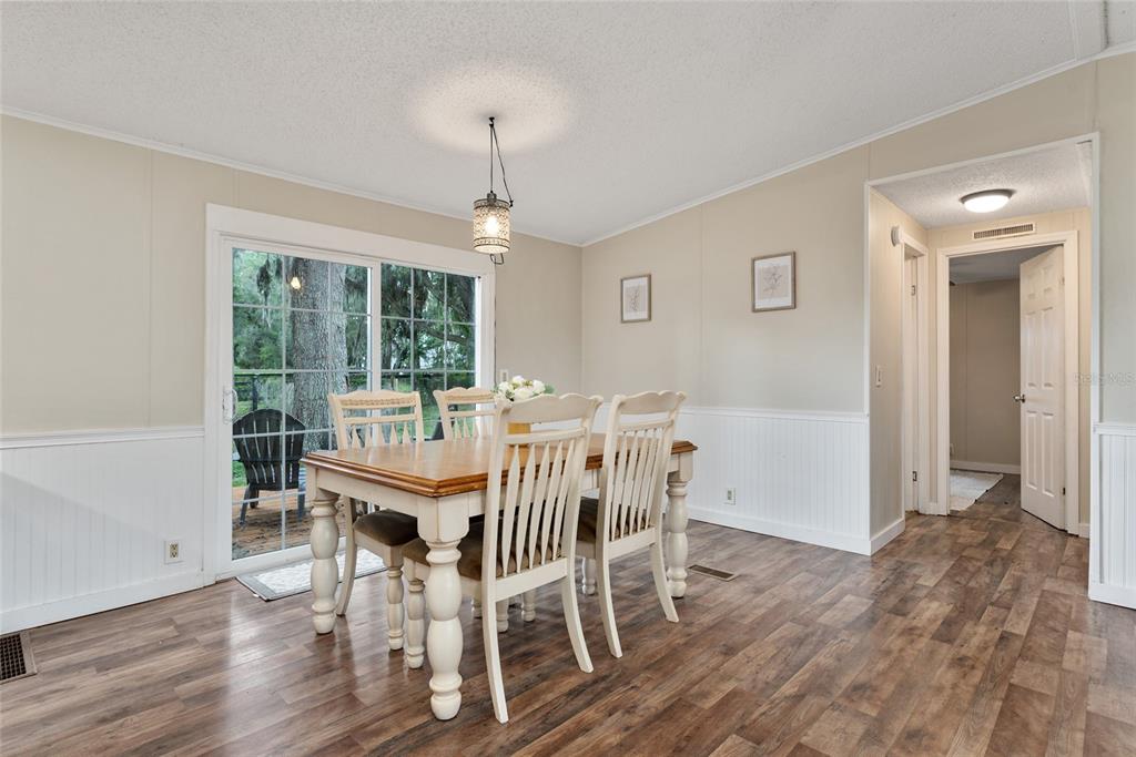 15305 Northwest 112th Place Road Morriston, FL 32668 - Photo 57 of 95 a view of a dining room with furniture window and wooden floor