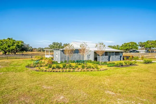 a view of an ocean with a table and chairs
