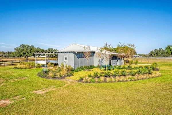 a backyard of a house with yard and outdoor seating