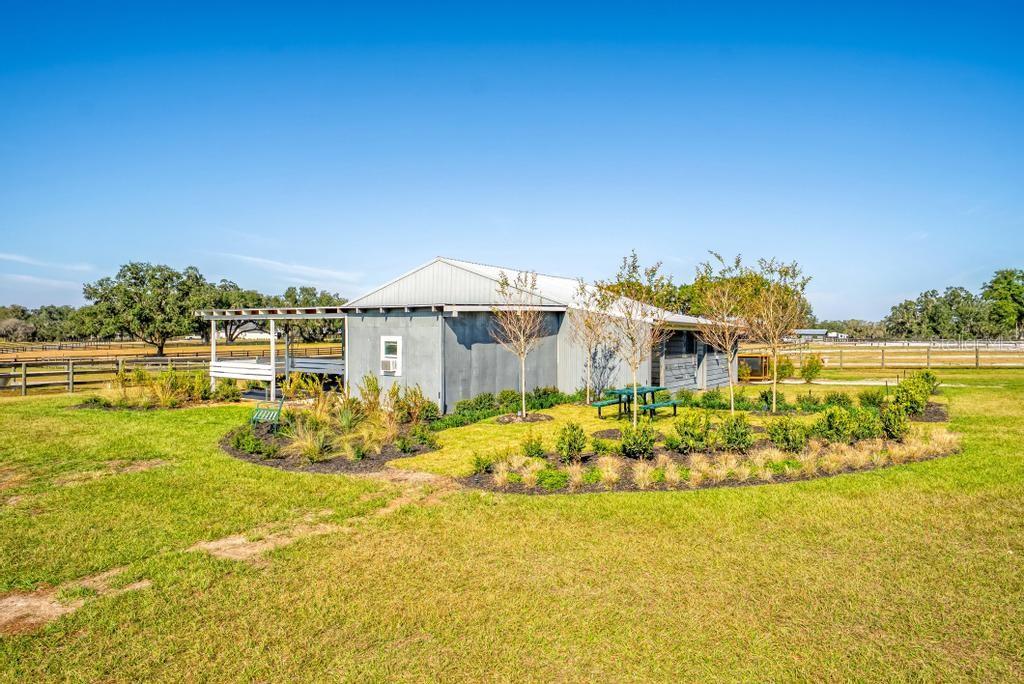 15305 Northwest 112th Place Road Morriston, FL 32668 - Photo 9 of 95 a view of a swimming pool with an ocean view
