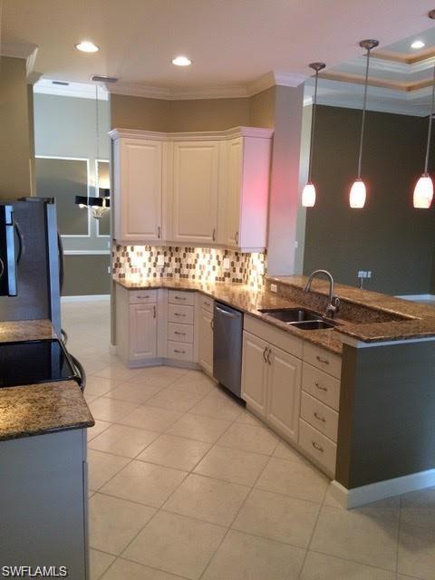 3200 Sundance Circle Naples, FL 34109 - Photo 2 of 6 a large kitchen with granite countertop a sink and a stove