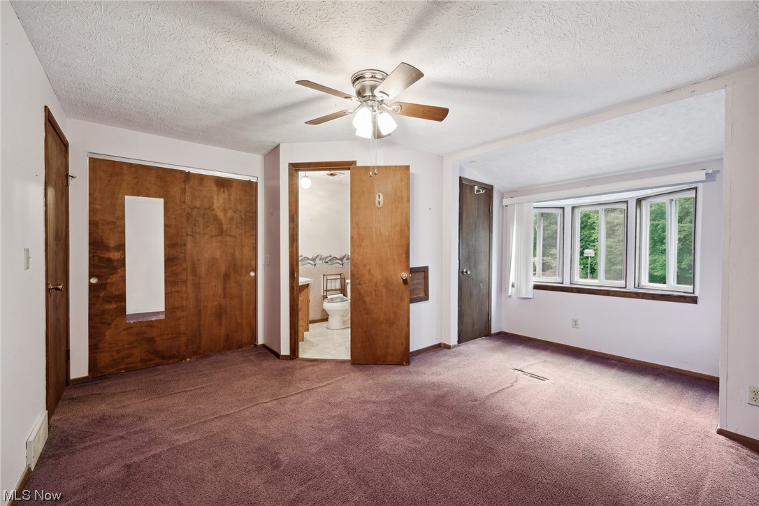 2715 Douglas Road Ashtabula, OH 44004 - Photo 22 of 34 Carpeted bedroom with a textured ceiling, vaulted ceiling, and ceiling fan