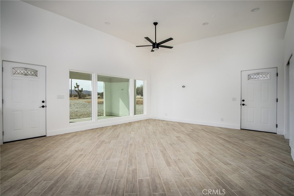 62474 Golden Street Joshua Tree, CA 92252 - Photo 11 of 31 a view of an empty room with wooden floor and a window