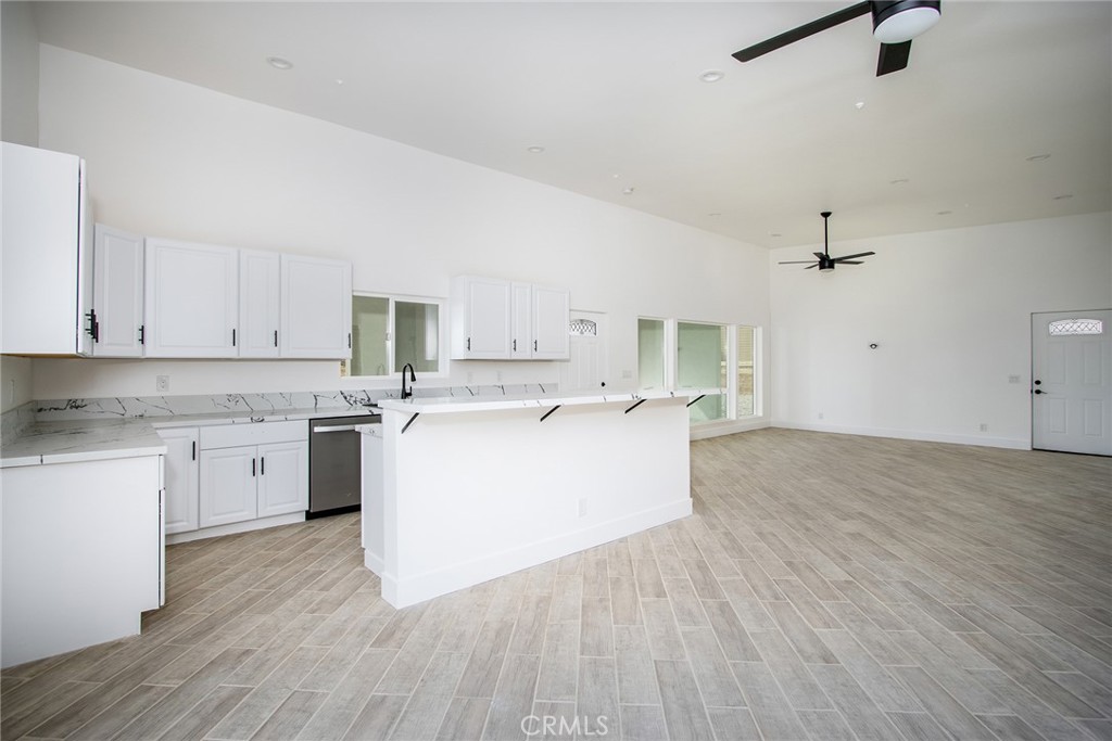 62474 Golden Street Joshua Tree, CA 92252 - Photo 14 of 31 a large white kitchen with a white stove top oven and white cabinets