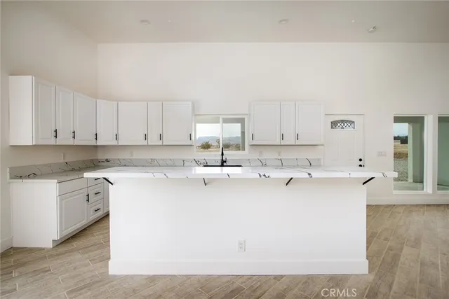 a kitchen with cabinets appliances a sink and a counter top space