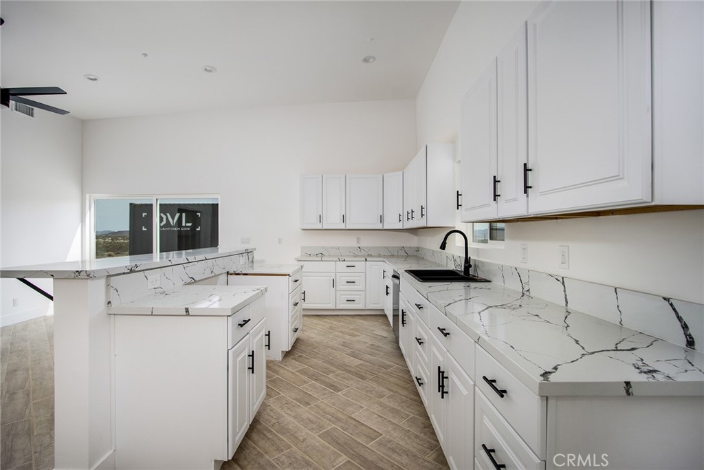 62474 Golden Street Joshua Tree, CA 92252 - Photo 17 of 31 a kitchen with stainless steel appliances white cabinets sink and a stove