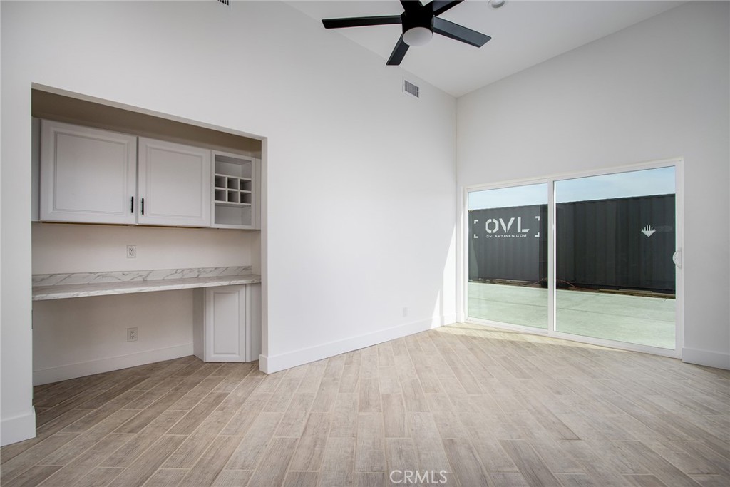 62474 Golden Street Joshua Tree, CA 92252 - Photo 19 of 31 a view of an empty room with a window and wooden floor