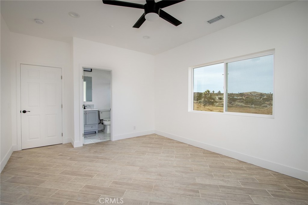 62474 Golden Street Joshua Tree, CA 92252 - Photo 21 of 31 an empty room with a empty space and a ceiling fan