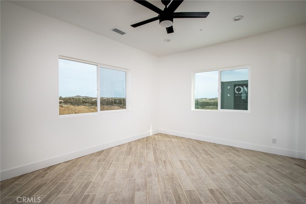 62474 Golden Street Joshua Tree, CA 92252 - Photo 23 of 31 wooden floor in an empty room with a window