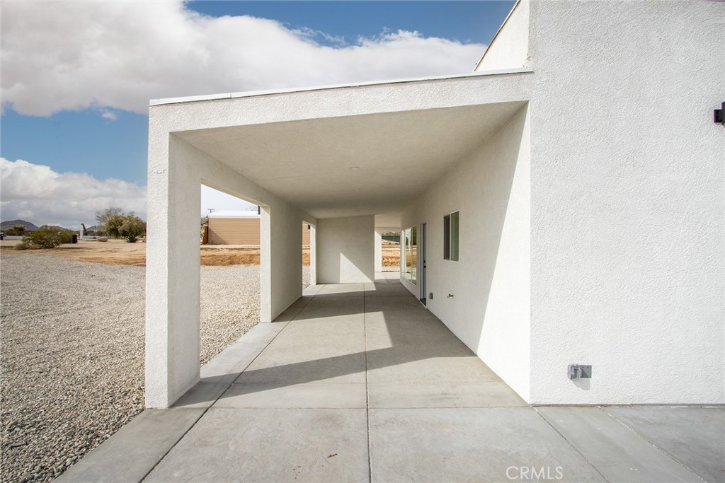 62474 Golden Street Joshua Tree, CA 92252 - Photo 8 of 31 a view of a big room with wooden floor and windows