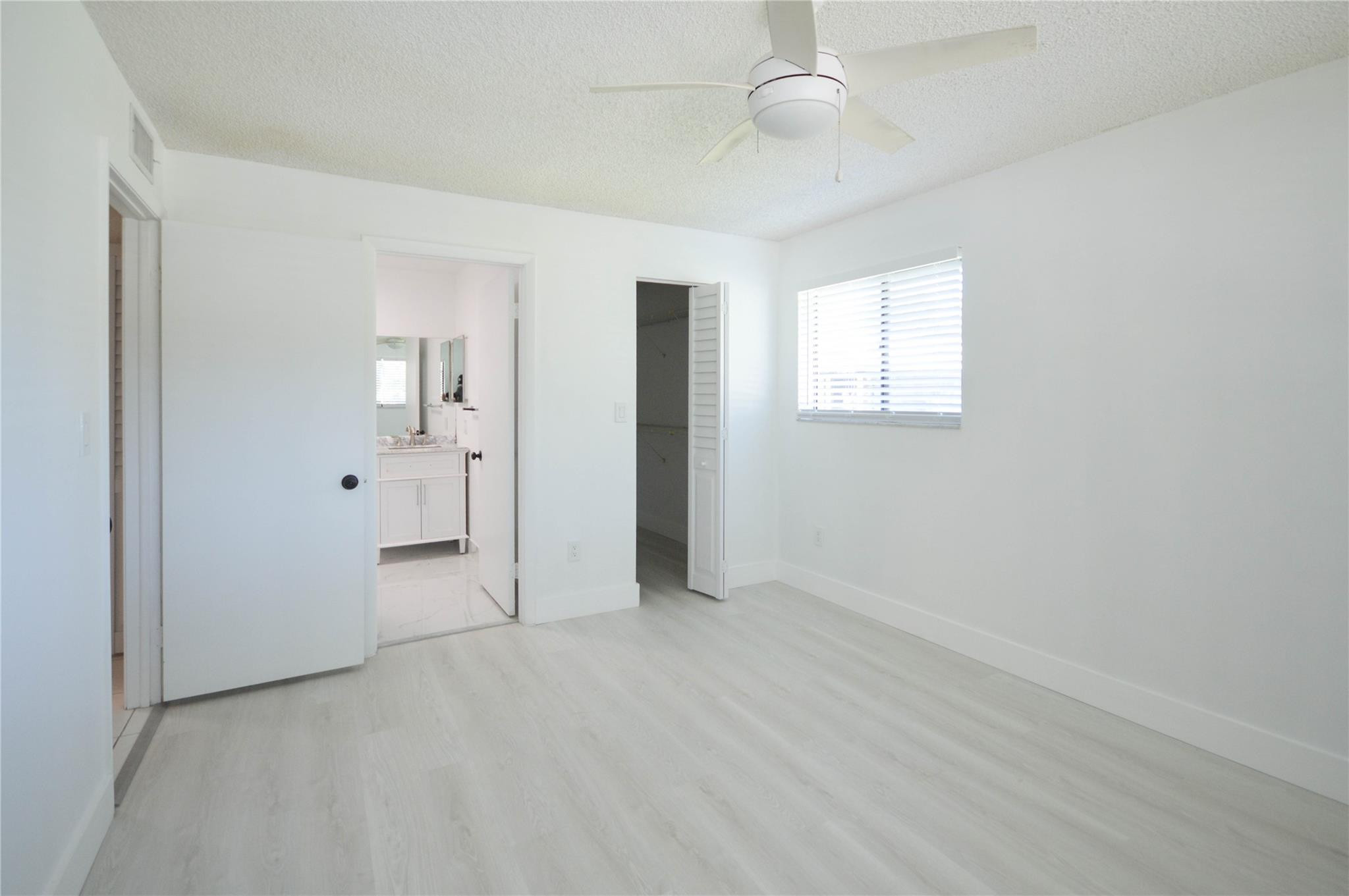 9499 West McNab Road, Unit 208 Tamarac, FL 33321 - Photo 6 of 19 an empty room with fan and entrance