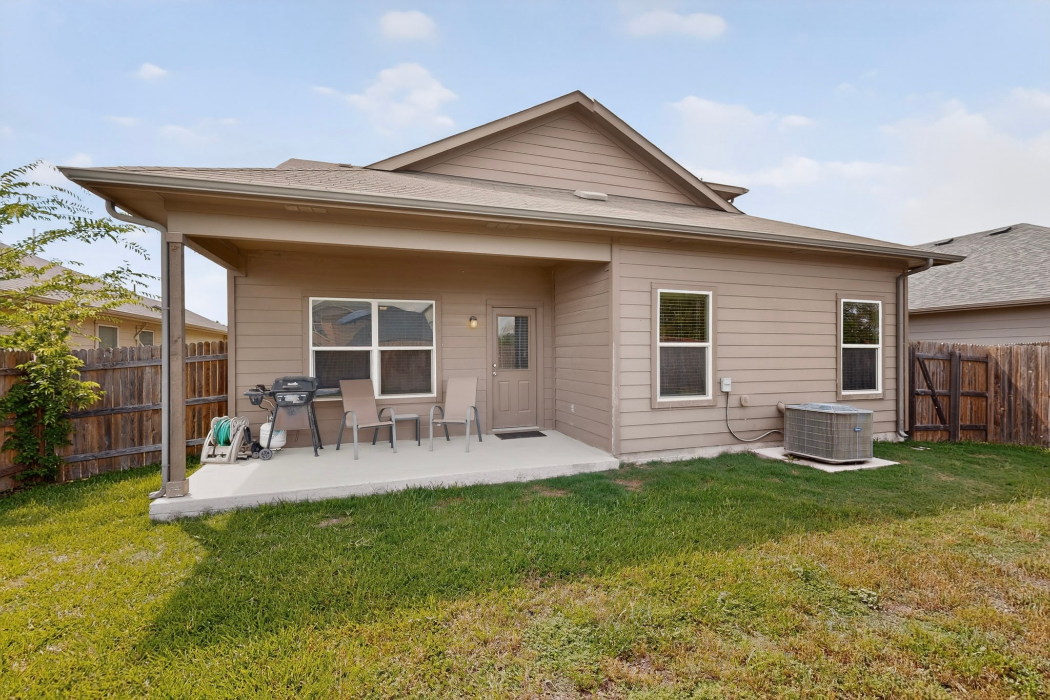 14513 Esker Road Manor, TX 78653 - Photo 32 of 38 A private covered patio extends from the home, perfect for outdoor relaxation.