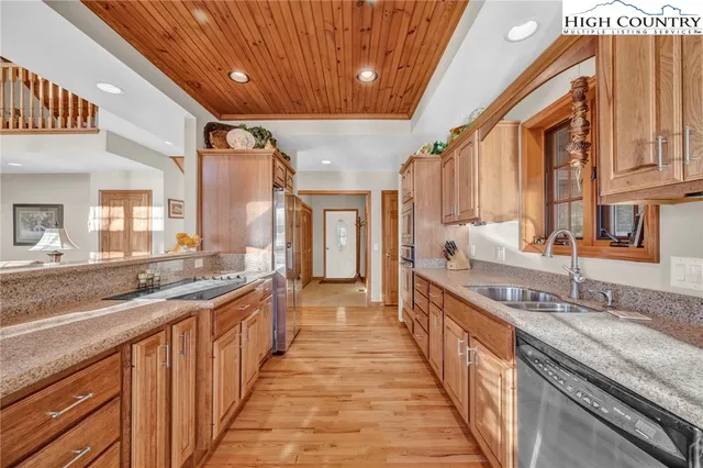 a large kitchen with stainless steel appliances granite countertop lots of counter top space