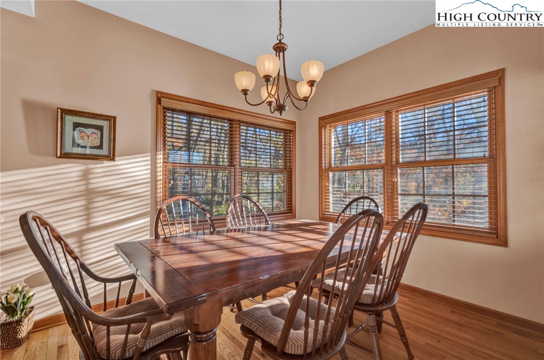 121 Spruce Hollow Road Beech Mountain, NC 28604 - Photo 15 of 50 a view of a dining room with furniture window and wooden floor