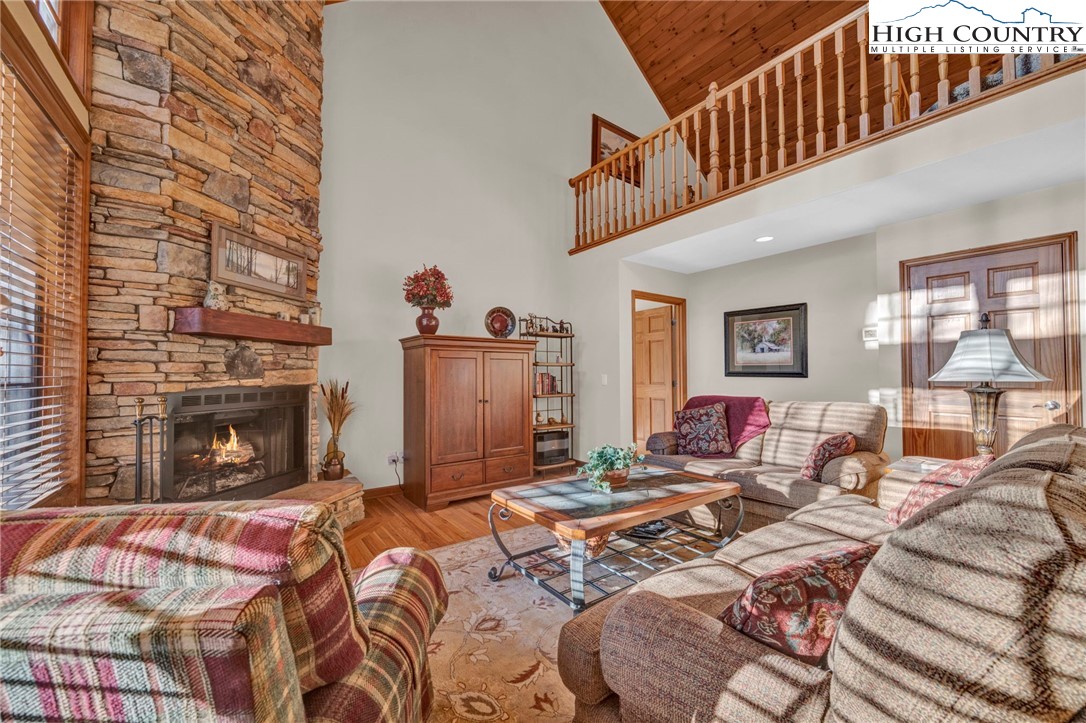 121 Spruce Hollow Road Beech Mountain, NC 28604 - Photo 16 of 50 a bed room with a bed and a fireplace