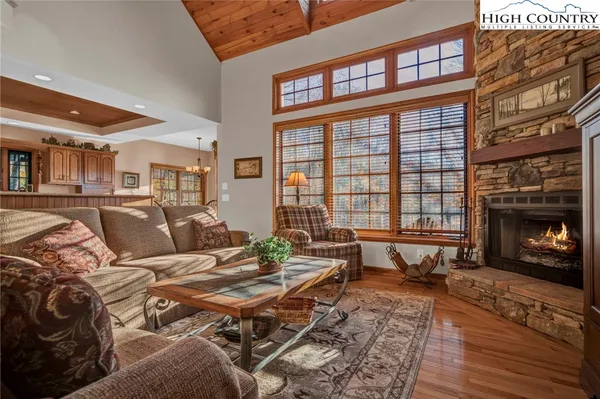 a living room with furniture large window and a fireplace