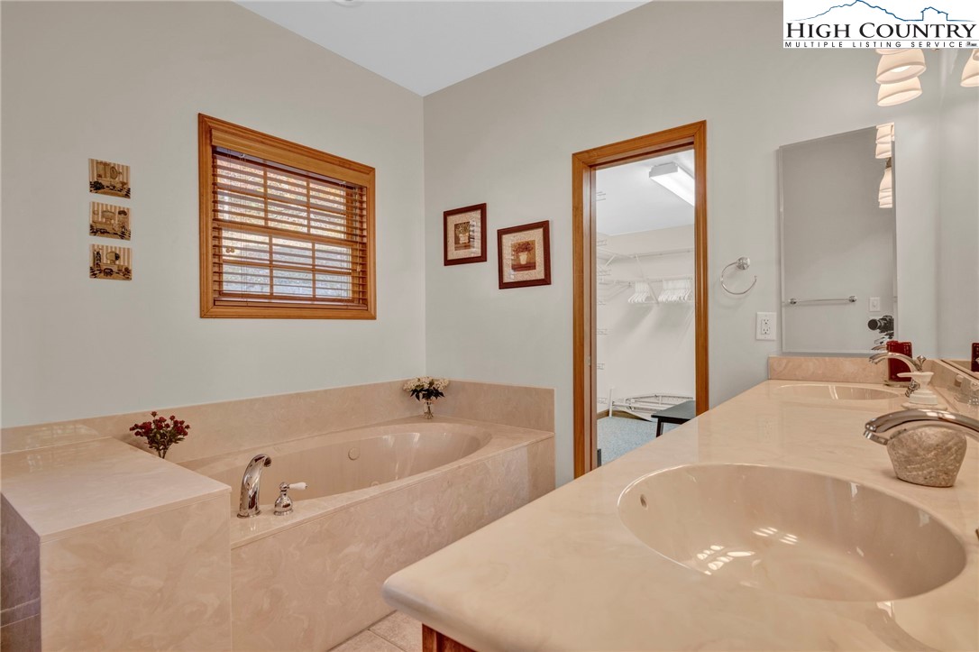 121 Spruce Hollow Road Beech Mountain, NC 28604 - Photo 20 of 50 a bath tub sitting next to a white sink