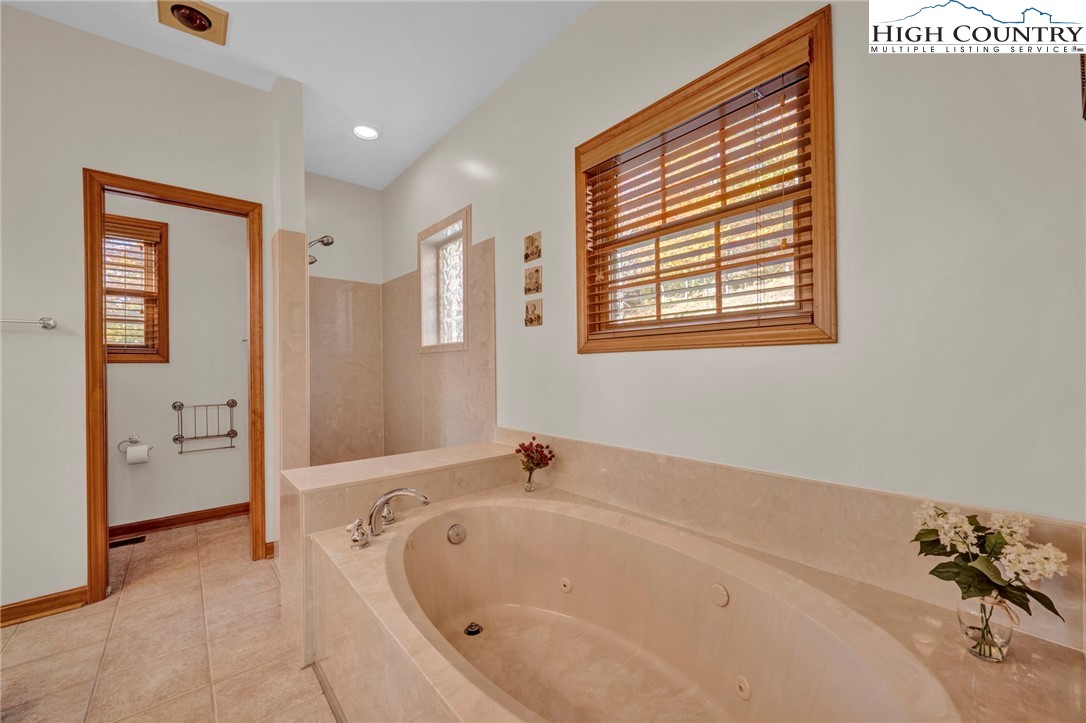 121 Spruce Hollow Road Beech Mountain, NC 28604 - Photo 21 of 50 a bathroom with a tub and a shower