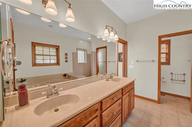 a bathroom with a sink double vanity and a mirror