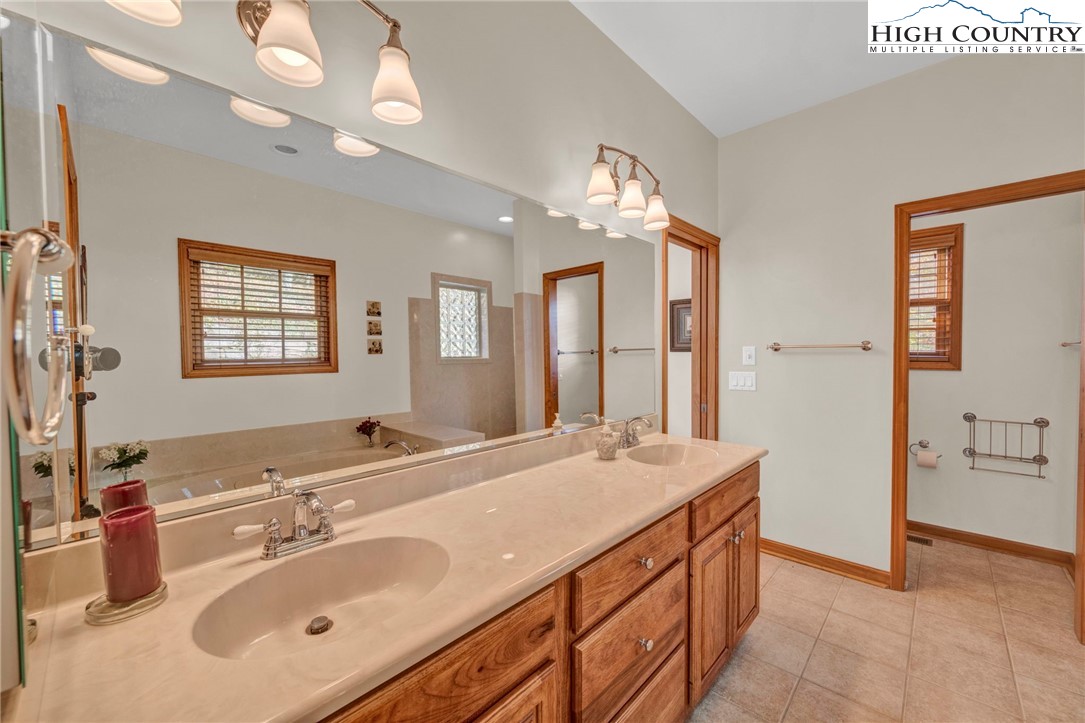 121 Spruce Hollow Road Beech Mountain, NC 28604 - Photo 22 of 50 a bathroom with a sink double vanity and a mirror