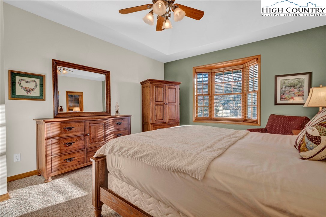 121 Spruce Hollow Road Beech Mountain, NC 28604 - Photo 23 of 50 a bedroom with a bed and a dresser